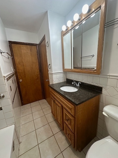 bathroom with decorative backsplash, tile walls, toilet, tile patterned floors, and vanity