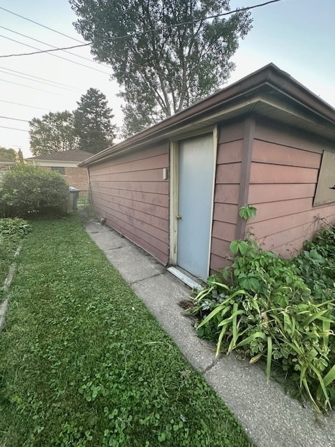 view of outdoor structure featuring a lawn