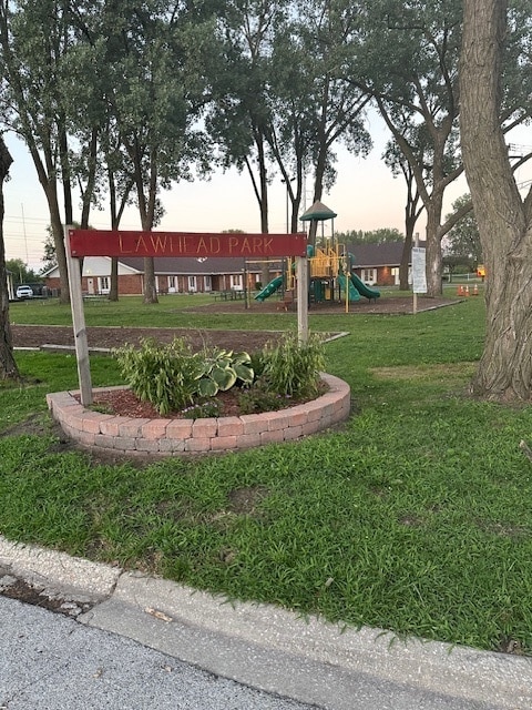 view of property's community featuring a playground and a lawn