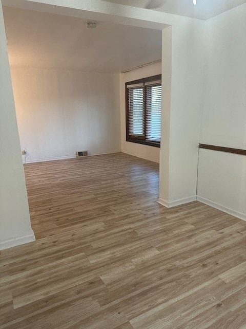 unfurnished room with light hardwood / wood-style floors