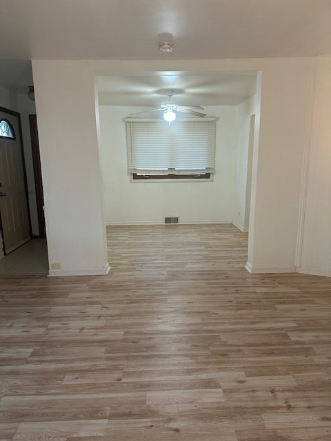 unfurnished room featuring ceiling fan and light wood-type flooring