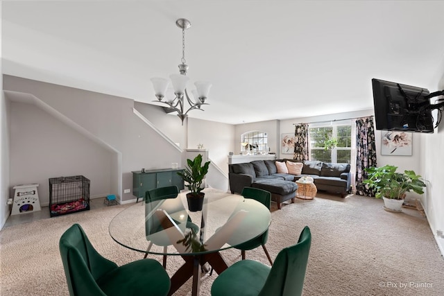 dining area featuring carpet flooring and an inviting chandelier