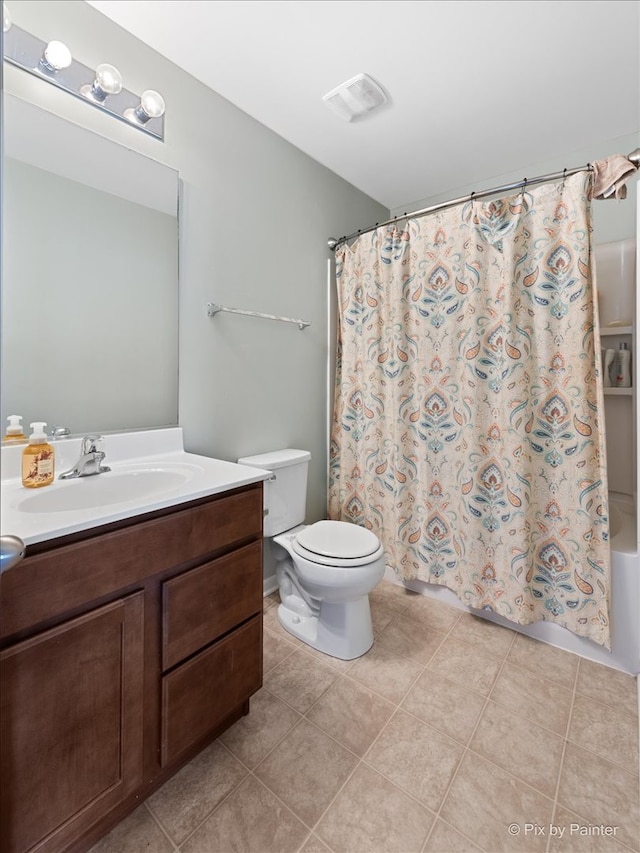 full bathroom with toilet, shower / tub combo, vanity, and tile patterned flooring