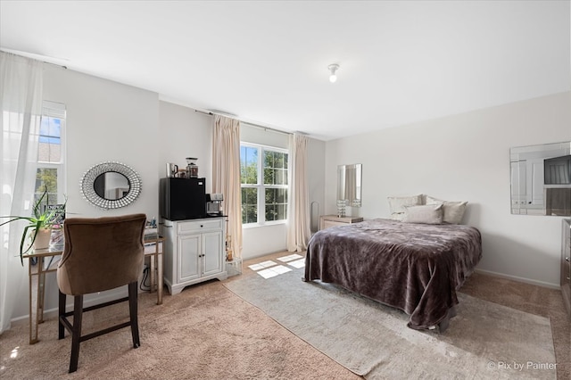 bedroom featuring light carpet