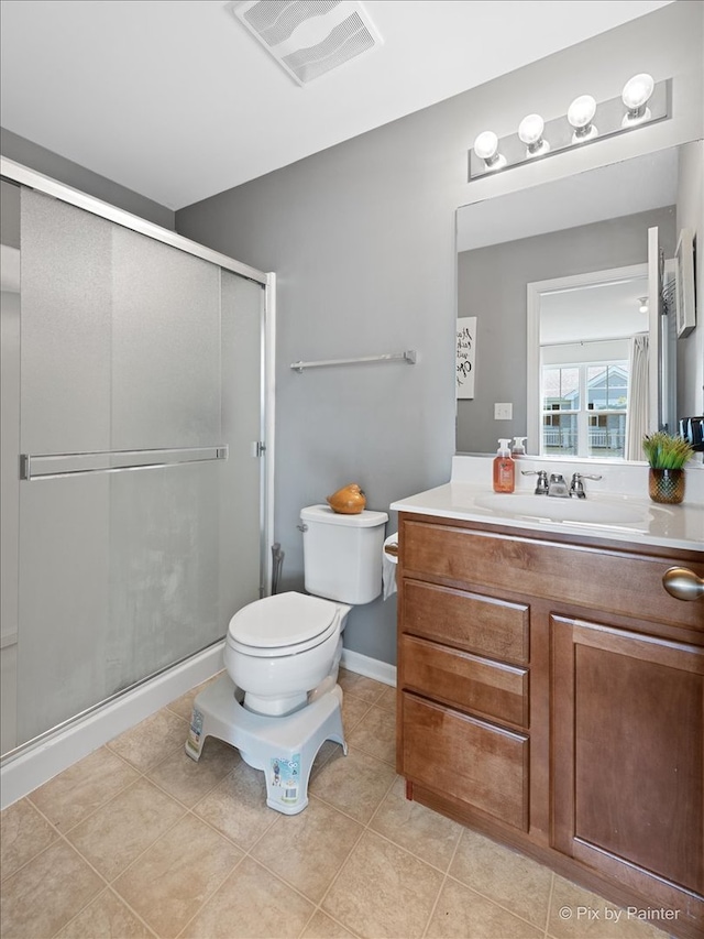 bathroom featuring a shower with door, toilet, tile patterned floors, and vanity