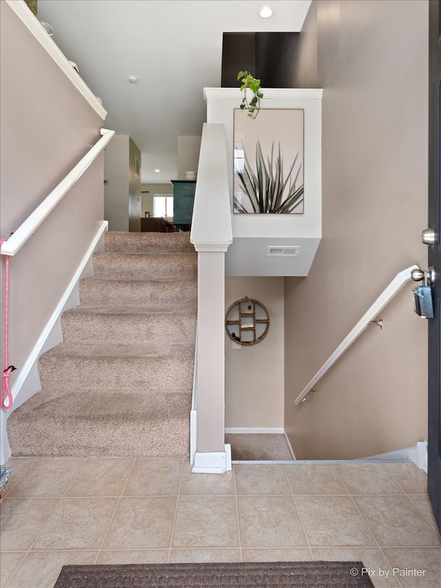 staircase featuring tile patterned floors