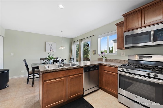 kitchen with range, dishwashing machine, light tile patterned floors, sink, and kitchen peninsula