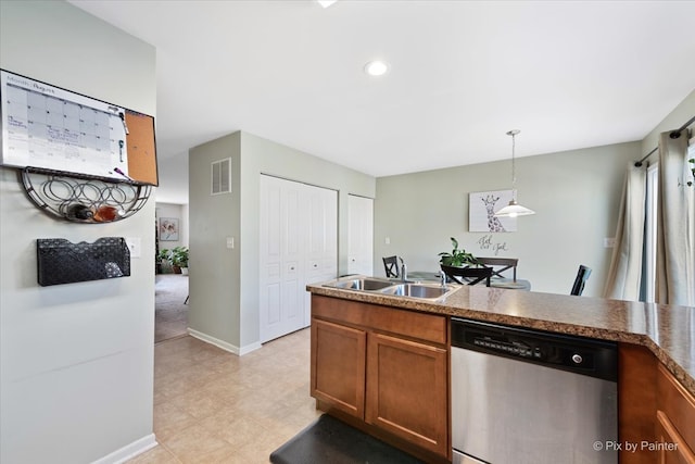 kitchen featuring light tile patterned flooring, sink, stainless steel dishwasher, and hanging light fixtures