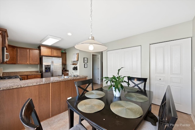 dining room with light tile patterned floors and sink