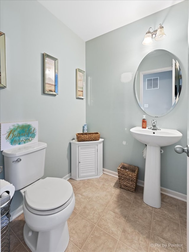 bathroom featuring tile patterned flooring and toilet