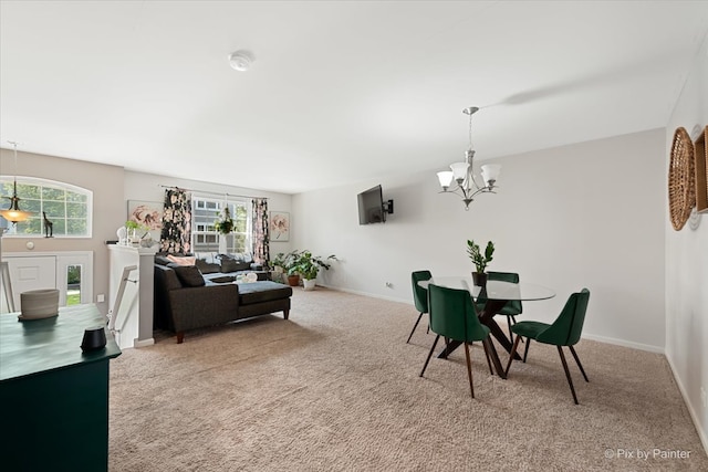 dining area with a notable chandelier and carpet flooring