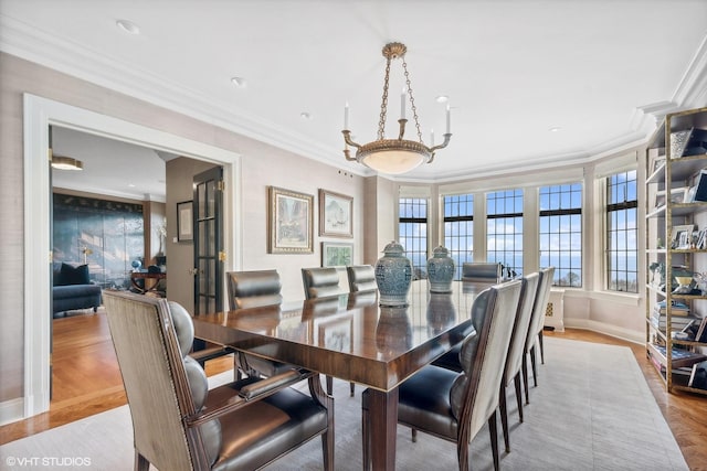 dining room featuring crown molding and light hardwood / wood-style floors