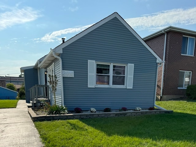 view of property exterior with a lawn