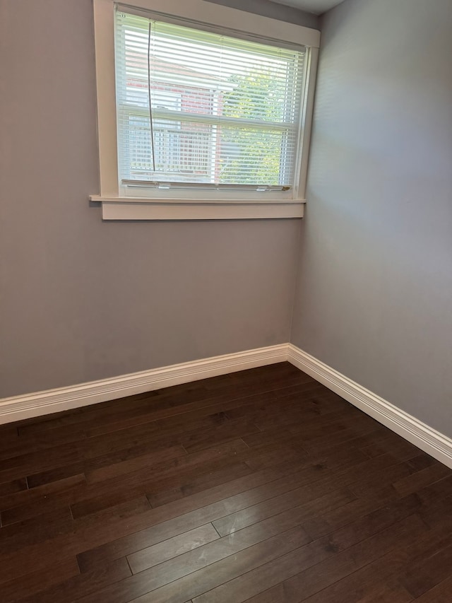 unfurnished room featuring dark hardwood / wood-style floors