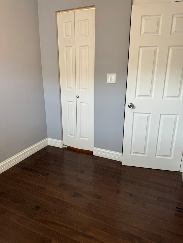 unfurnished bedroom featuring dark wood-type flooring