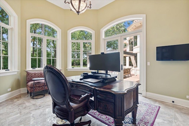 home office featuring an inviting chandelier