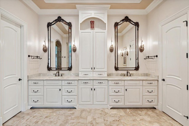 bathroom featuring ornamental molding and vanity