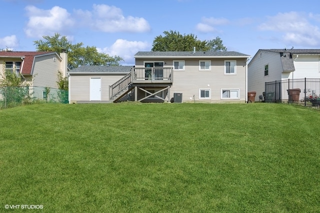 back of house featuring a lawn, central AC, and a wooden deck