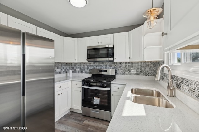 kitchen featuring dark hardwood / wood-style floors, sink, stainless steel appliances, and decorative backsplash