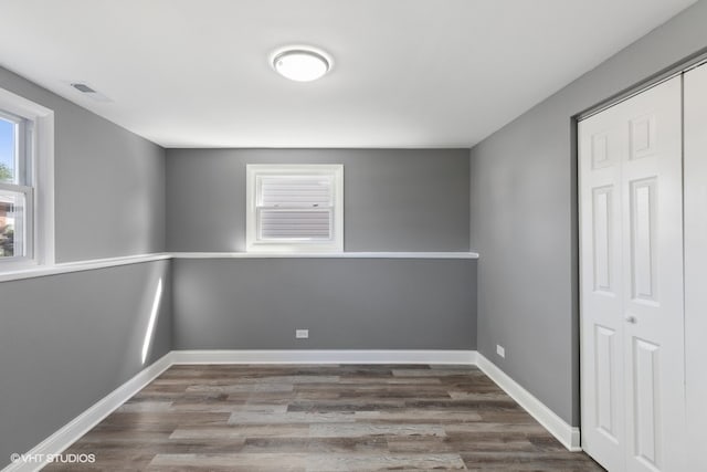 unfurnished room with wood-type flooring