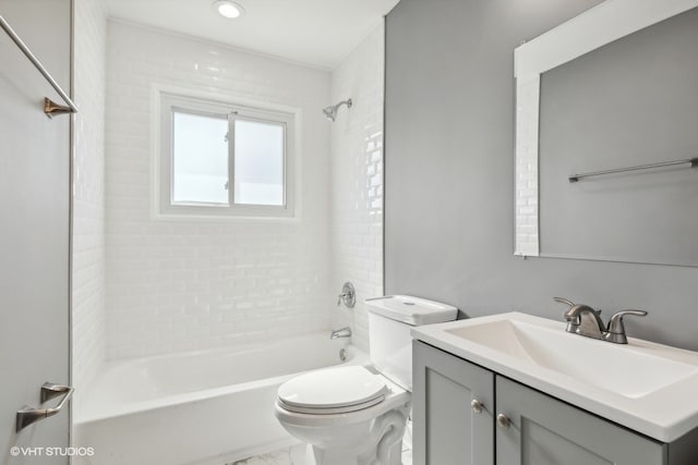 full bathroom featuring tiled shower / bath, toilet, and vanity