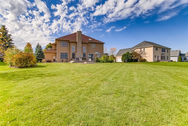 rear view of house featuring a yard and a patio