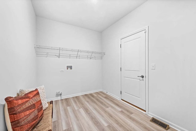 laundry room featuring light hardwood / wood-style flooring and washer hookup