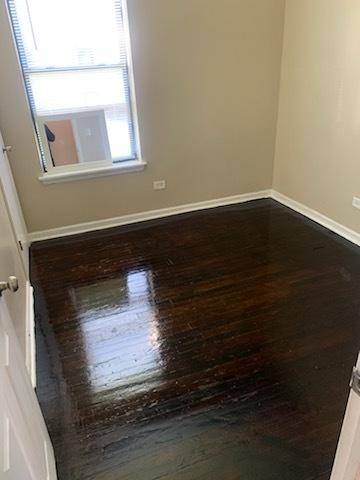 unfurnished room with hardwood / wood-style flooring