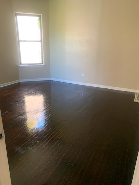 empty room featuring dark hardwood / wood-style flooring