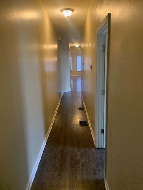 hall with dark hardwood / wood-style floors