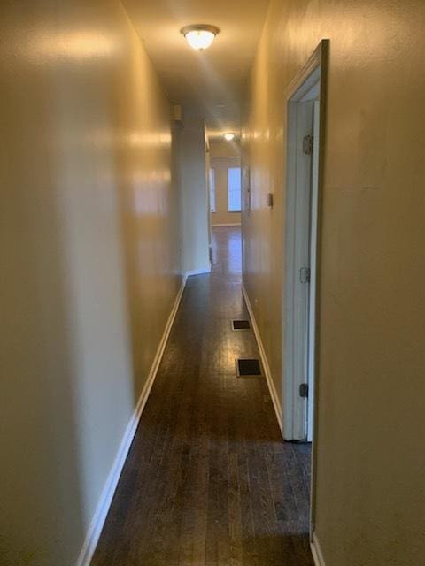 hallway featuring dark wood-type flooring