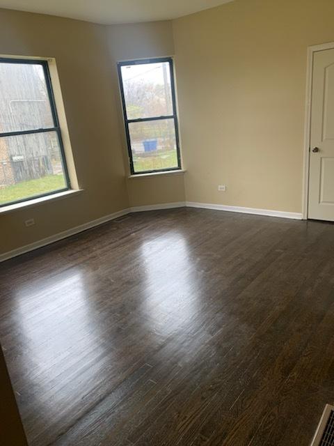 spare room with dark wood-type flooring