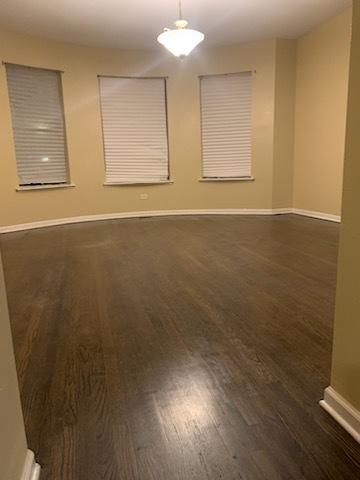 unfurnished room with dark wood-type flooring