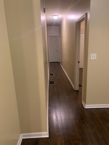 hall with dark hardwood / wood-style floors