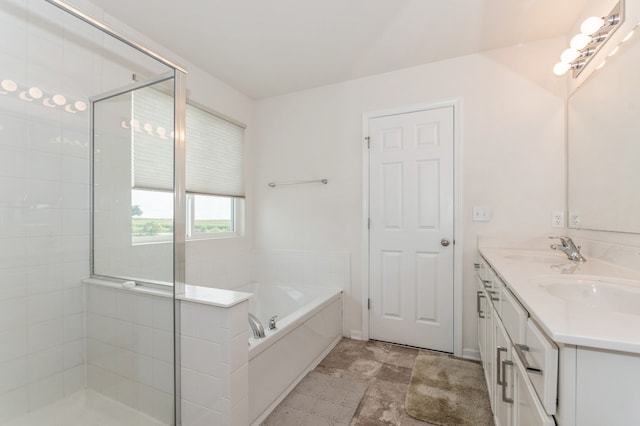 bathroom with vanity and independent shower and bath