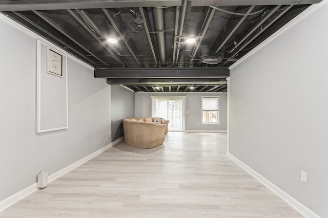 basement with light hardwood / wood-style floors