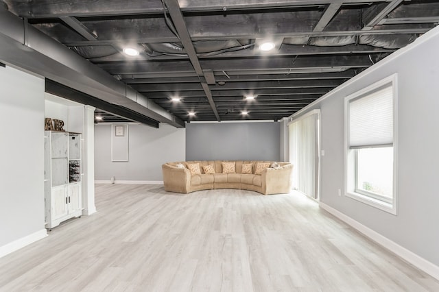 basement with light hardwood / wood-style flooring