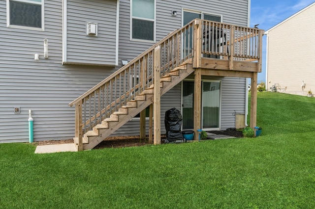 back of house featuring a lawn and a deck