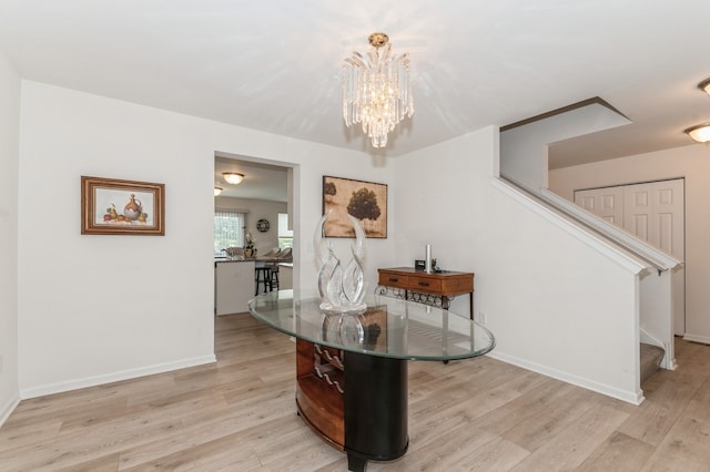 dining space with a chandelier and light hardwood / wood-style floors