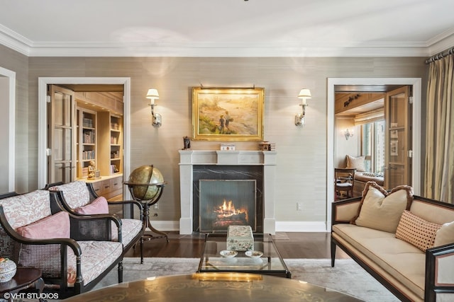 living area with a high end fireplace, ornamental molding, and dark hardwood / wood-style floors