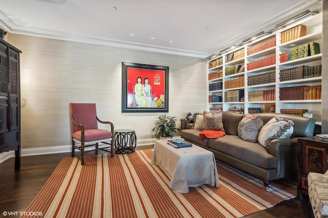 sitting room with wood-type flooring and ornamental molding