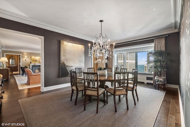 dining area featuring a water view, dark hardwood / wood-style floors, crown molding, and a chandelier