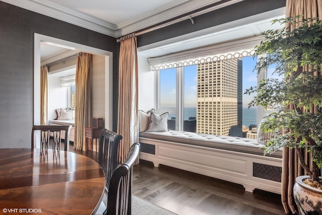 interior space featuring crown molding, hardwood / wood-style flooring, and a water view