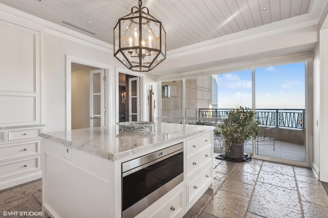 kitchen with pendant lighting, white cabinetry, wooden ceiling, and a center island