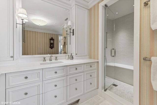 bathroom featuring walk in shower, vanity, and crown molding