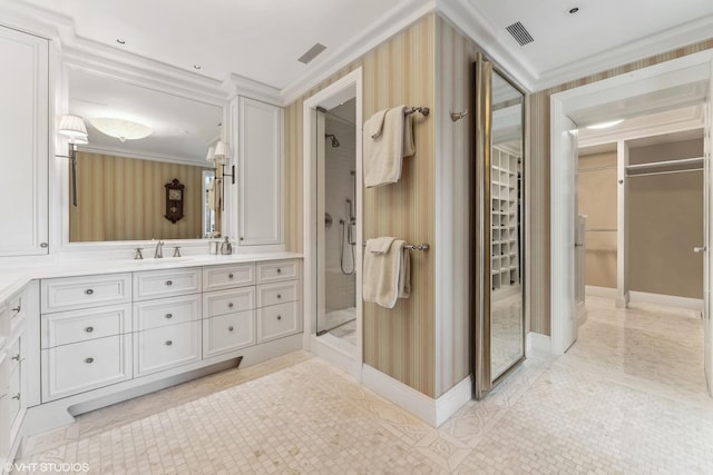 bathroom with crown molding, vanity, tile patterned floors, and walk in shower