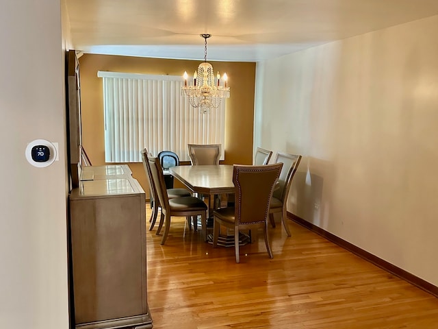 dining room featuring an inviting chandelier and light hardwood / wood-style flooring