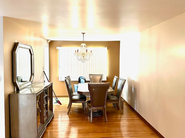 dining room featuring an inviting chandelier and light hardwood / wood-style floors