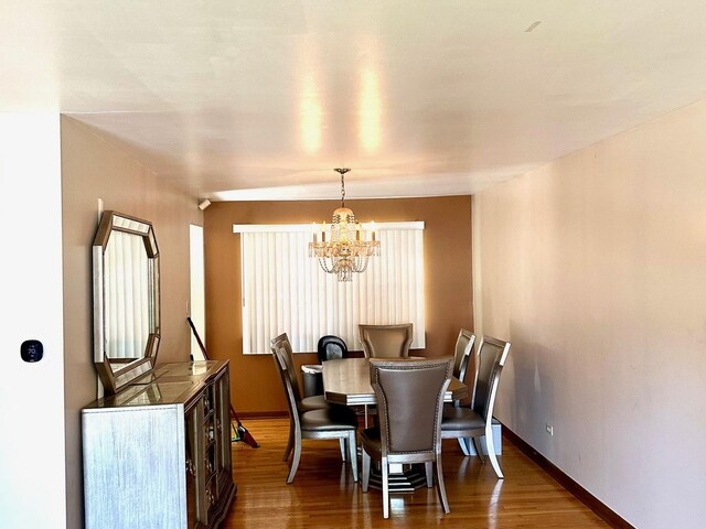 dining room featuring a notable chandelier and hardwood / wood-style flooring