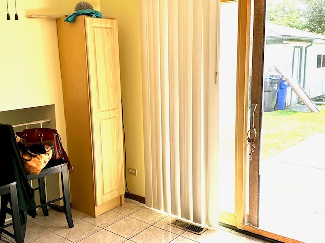 doorway to outside featuring light tile patterned flooring